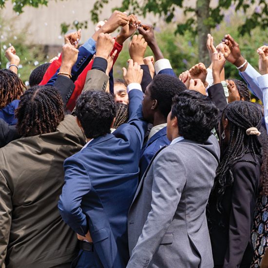 Simons Scholars group with hands up