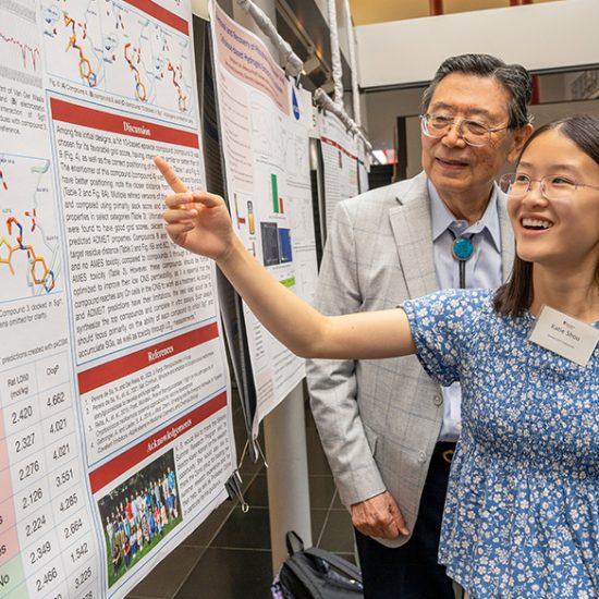 student and professor reviewing charts