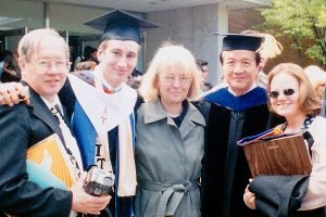 A family poses at a college graduation.