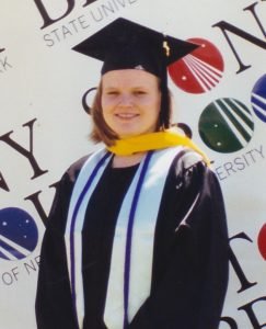 A college graduate in a cap and gown.